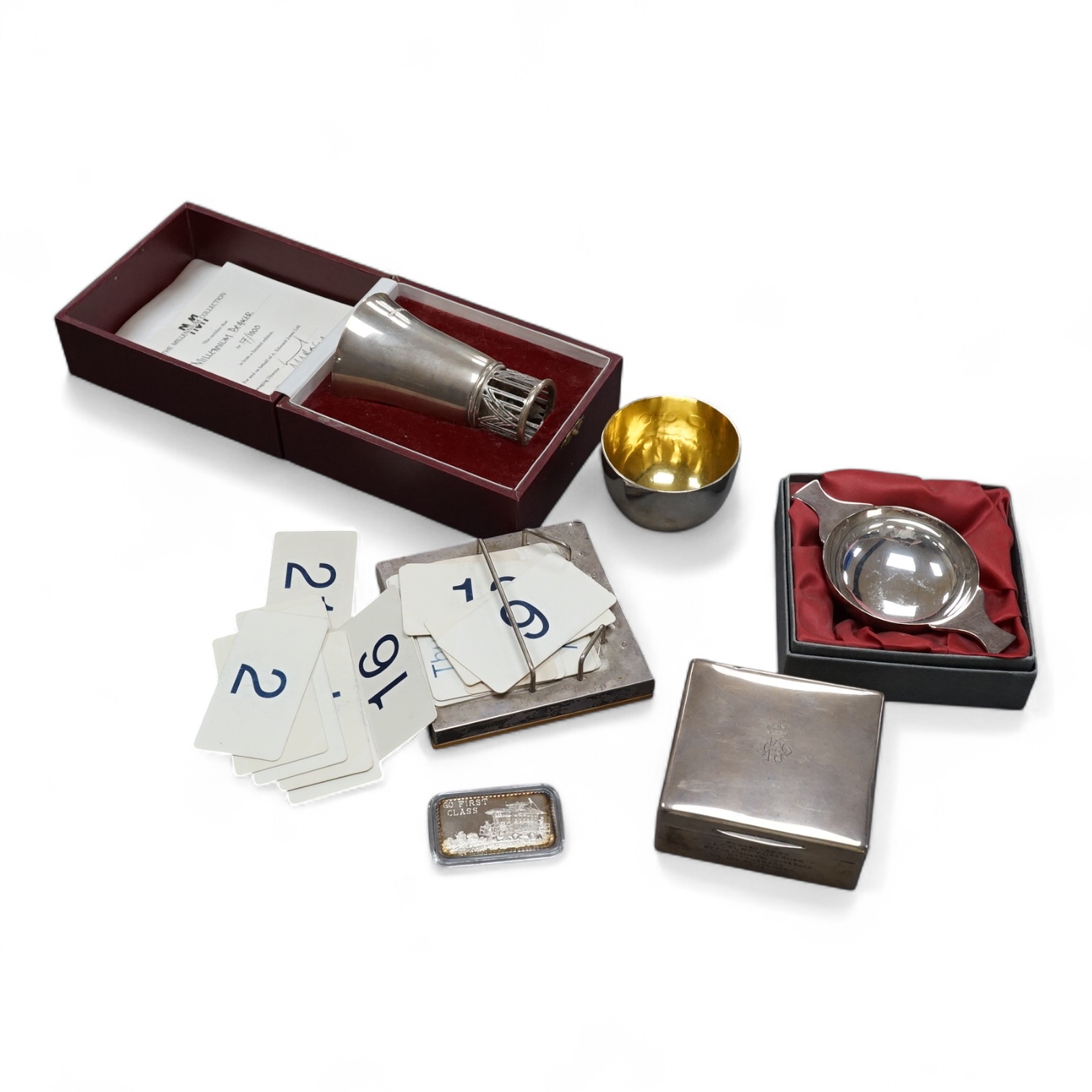 A modern silver limited edition 'Millennium Beaker' by A.E. Jones Ltd, Birmingham, 2000, no. 17/1000, 10cm, 104 grams, with box and certificate, together with a George V silver mounted cigarette box by Mappin & Webb, a m